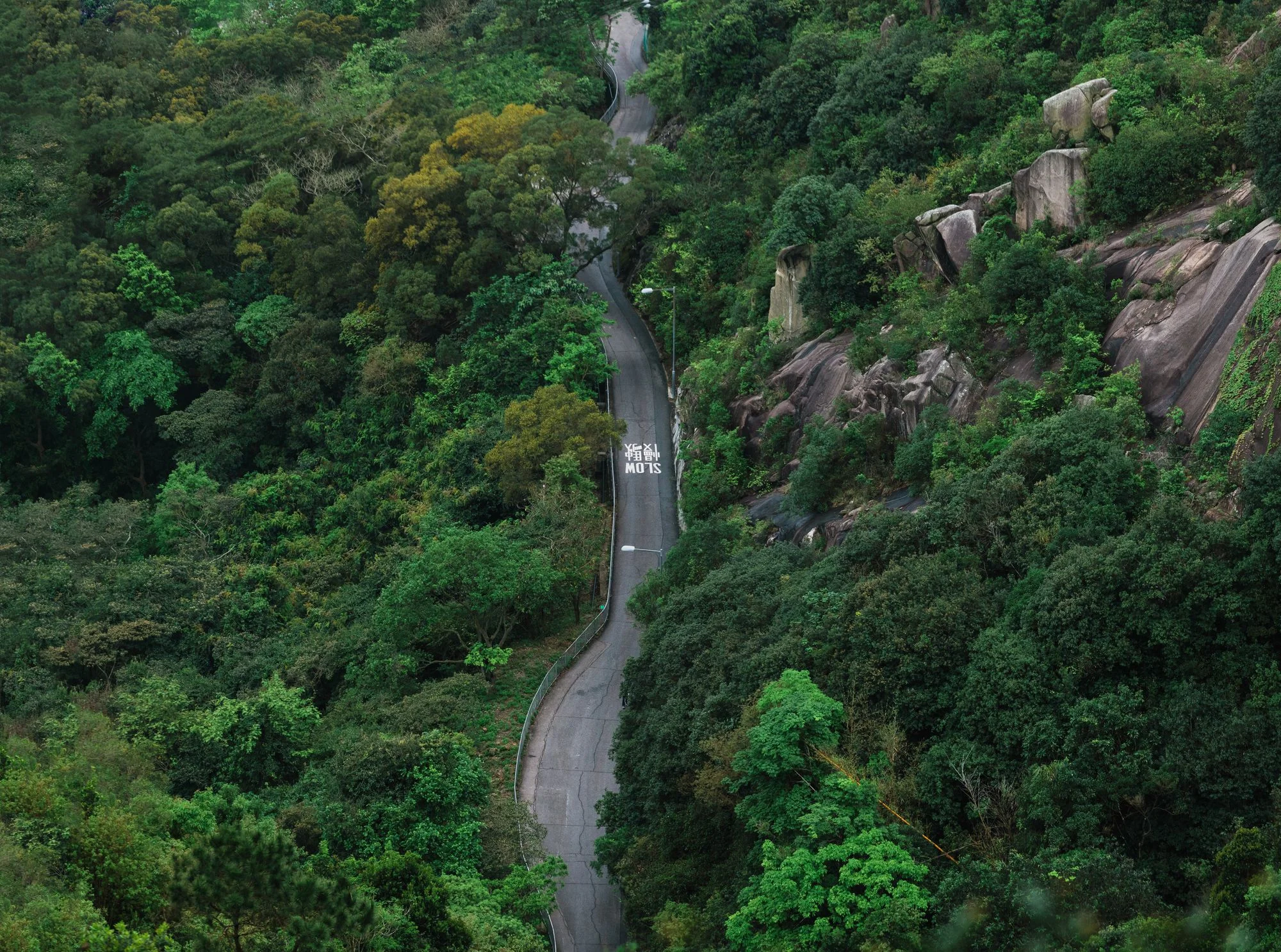 Chinese "Stop and Slow" sign marking on the road in the Valley of Hong Kong.